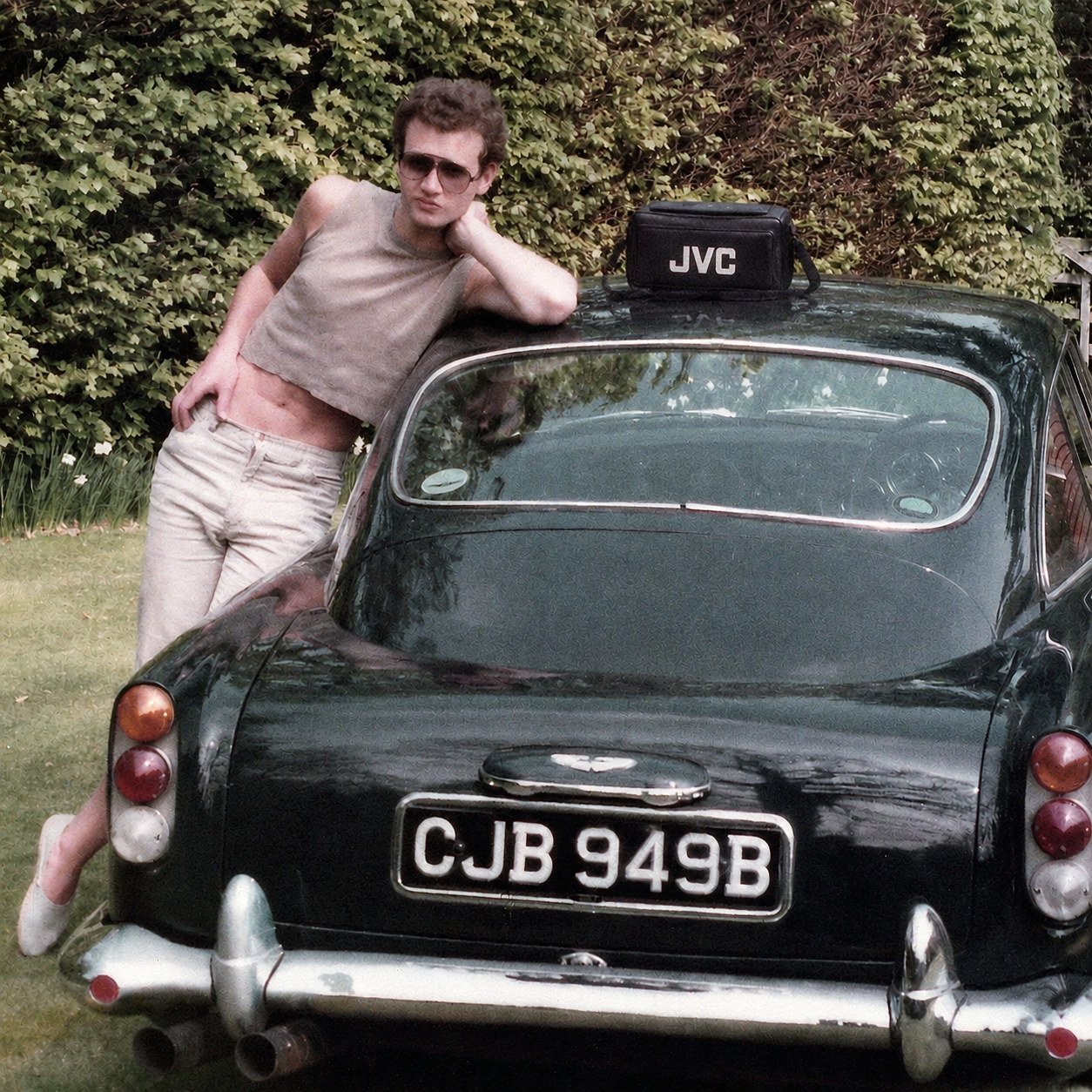 Richard leaning against the Aston Martin with his JVC camera in 1984