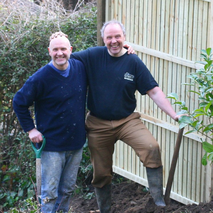 Mike and Richard smiling together in a garden in March 2015